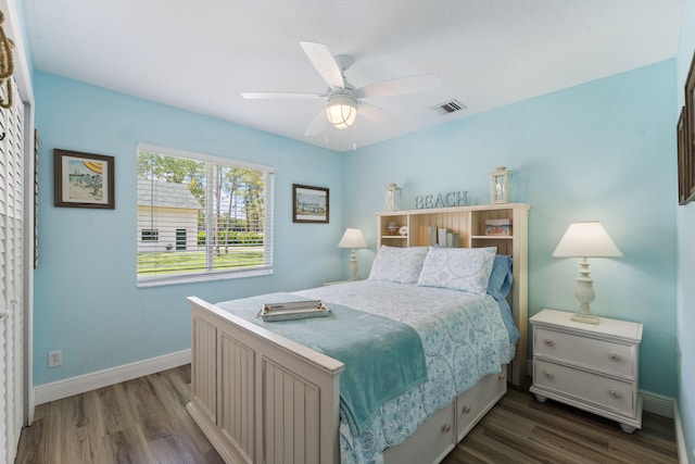 bedroom with ceiling fan and dark hardwood / wood-style floors