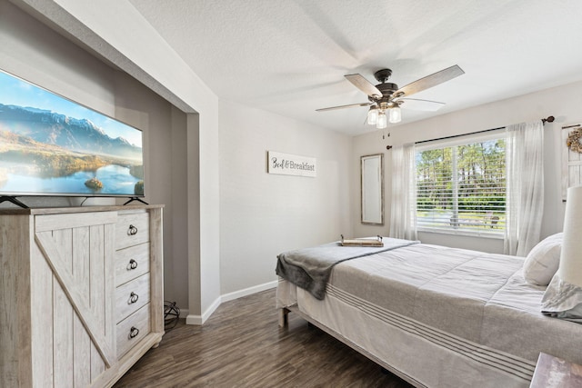 bedroom featuring ceiling fan, dark hardwood / wood-style flooring, and a textured ceiling