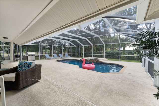 view of swimming pool with an in ground hot tub, a patio, and exterior kitchen