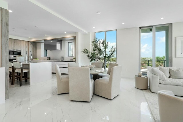 dining area featuring expansive windows and sink