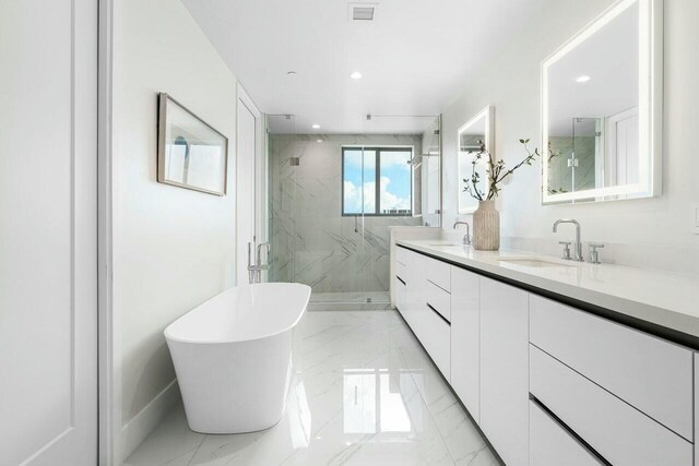 bathroom featuring vanity and shower with separate bathtub