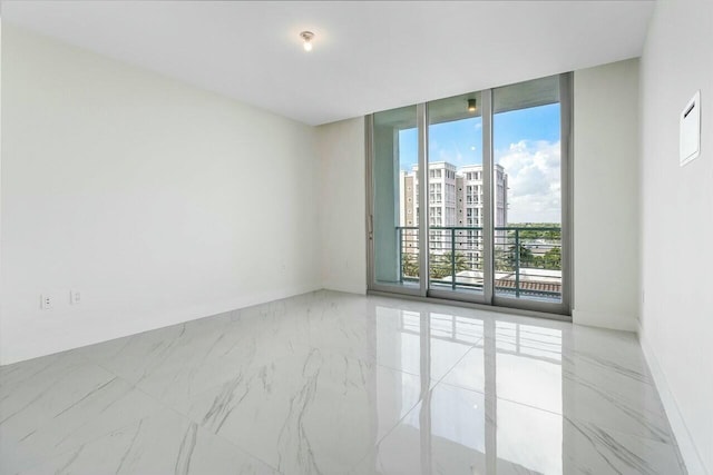 empty room featuring floor to ceiling windows and a healthy amount of sunlight