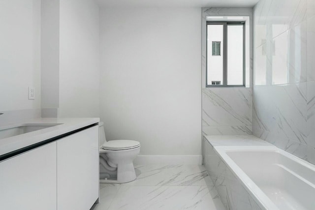 bathroom featuring vanity, toilet, and tiled tub