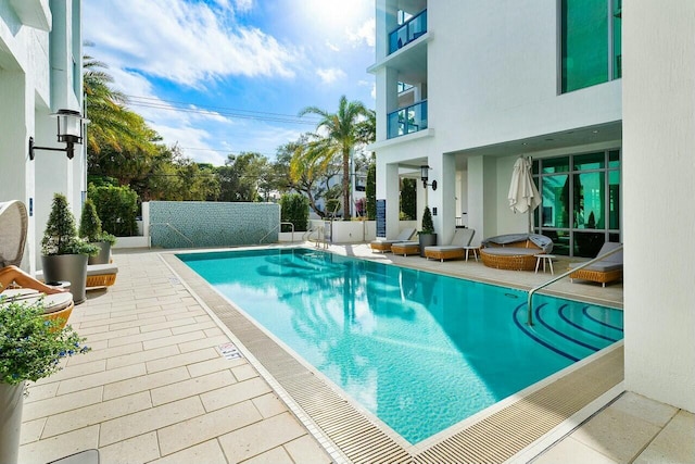 view of swimming pool with a patio