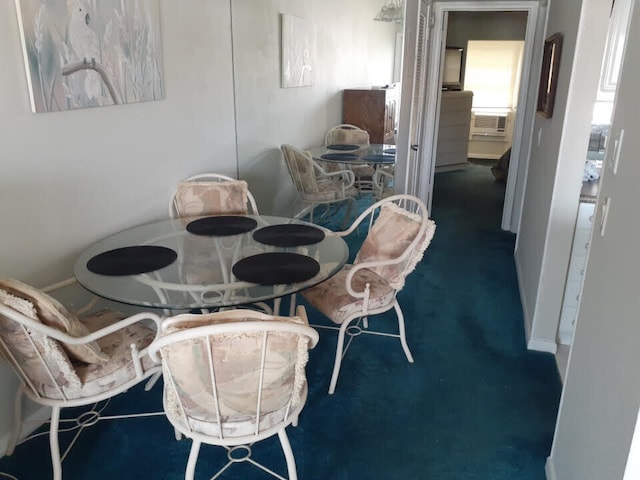 dining space featuring dark colored carpet