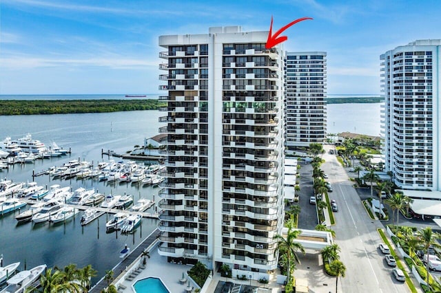 view of property with a water view and a city view