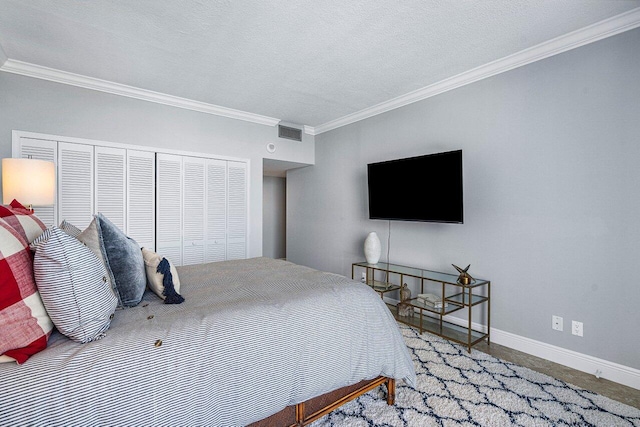 bedroom with a textured ceiling, crown molding, and a closet