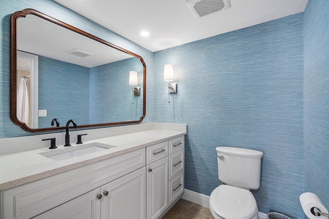 bathroom featuring vanity and toilet