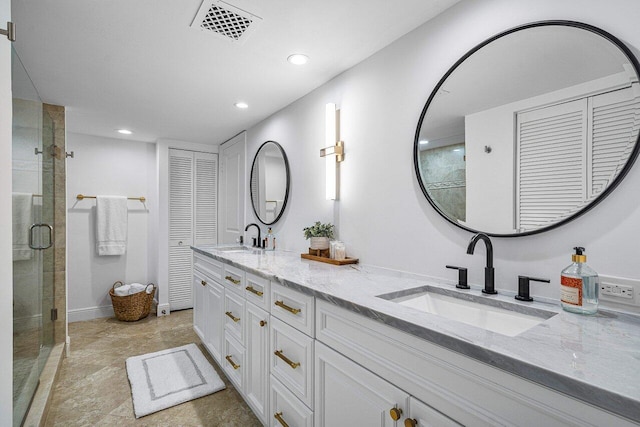 bathroom featuring vanity and a shower with door