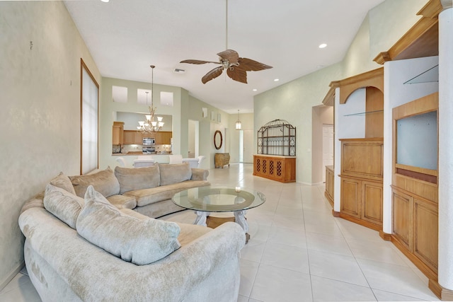 living room with ceiling fan with notable chandelier and light tile patterned floors