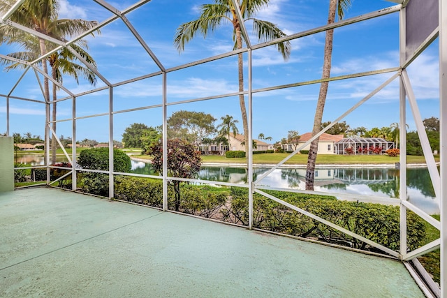 unfurnished sunroom featuring a water view