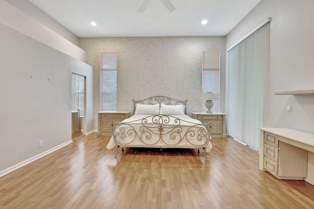 bedroom with ceiling fan and light wood-type flooring