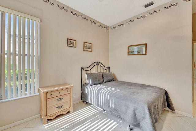 bedroom with light tile patterned floors