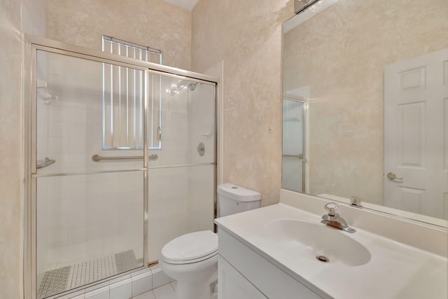 bathroom featuring tile patterned flooring, vanity, toilet, and an enclosed shower