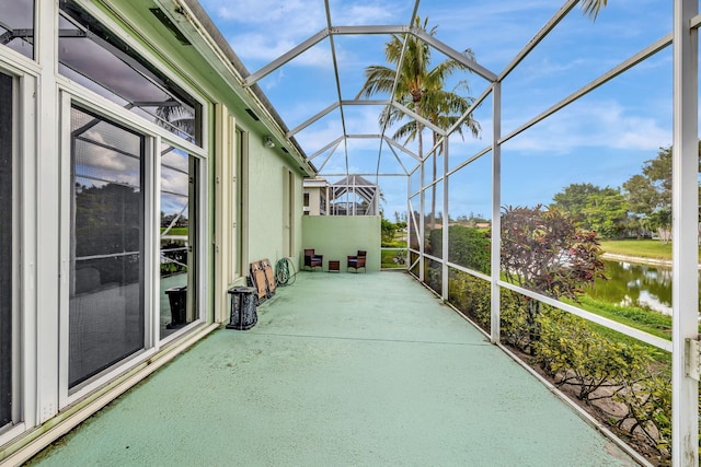 unfurnished sunroom featuring a water view