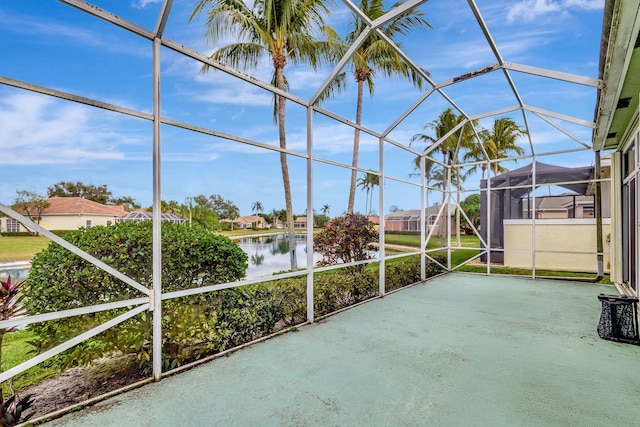 unfurnished sunroom featuring a water view