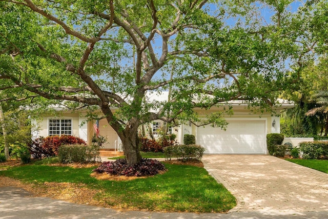 view of front of home with a front yard and a garage