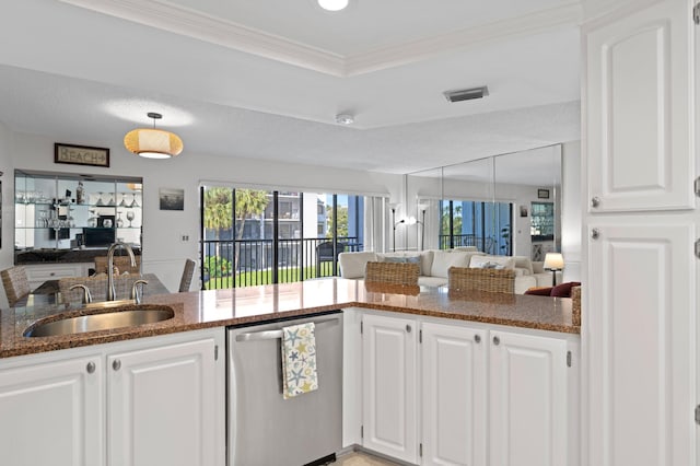 kitchen with stainless steel dishwasher, kitchen peninsula, white cabinetry, and sink