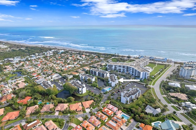 bird's eye view with a water view and a beach view