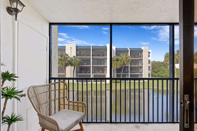 sunroom / solarium with a water view