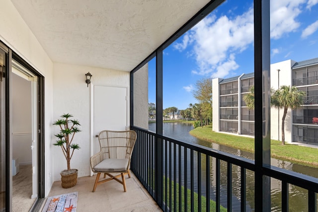 unfurnished sunroom featuring a water view