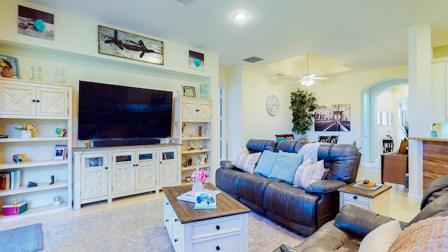 tiled living room with ceiling fan