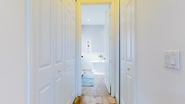 hallway with light wood-type flooring