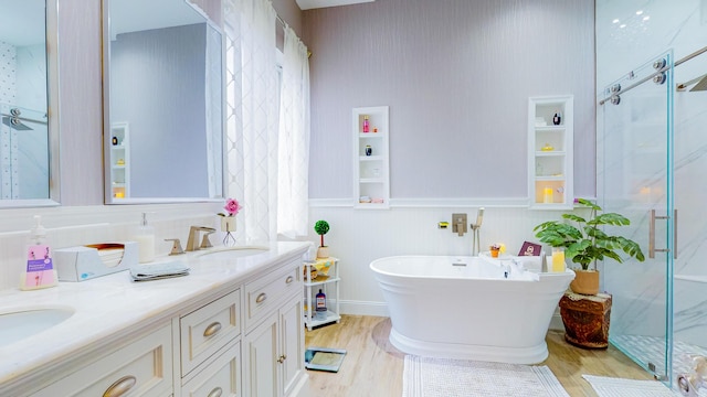 bathroom featuring wood-type flooring, vanity, and independent shower and bath