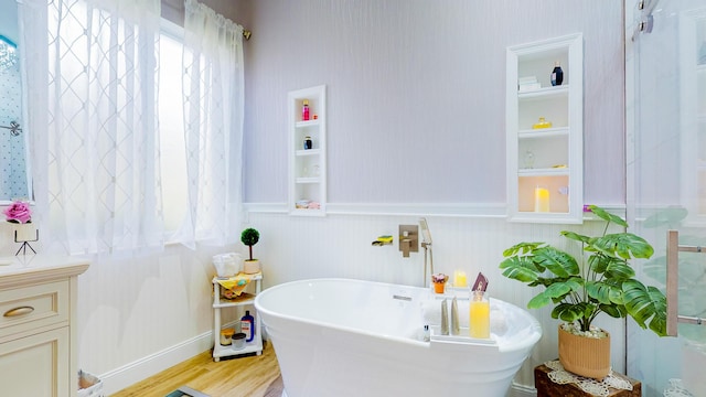 bathroom featuring a tub, hardwood / wood-style floors, and vanity