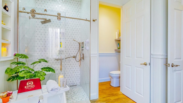 bathroom with toilet, wood-type flooring, and walk in shower