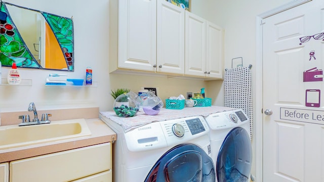 laundry area with sink, cabinets, and independent washer and dryer