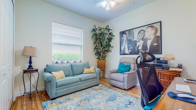 home office with hardwood / wood-style floors and ceiling fan