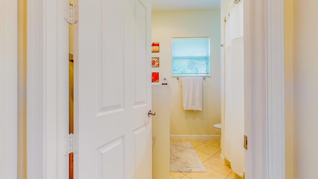 bathroom with tile patterned flooring and toilet