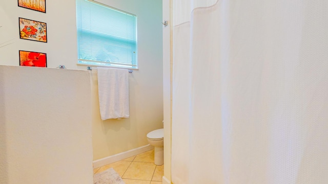 bathroom with toilet and tile patterned floors