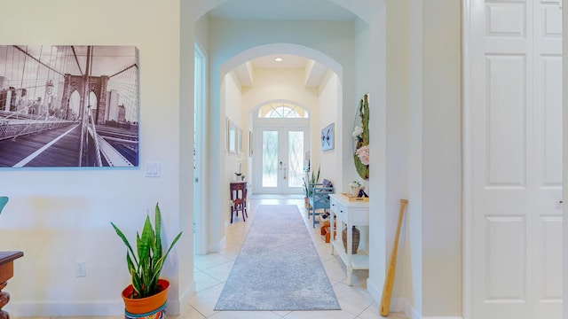 foyer entrance featuring french doors and light tile patterned flooring