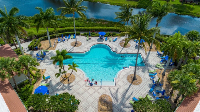 view of swimming pool with a water view and a patio