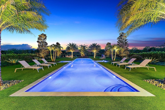 pool at dusk with a yard