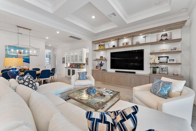 living room featuring beam ceiling, ornamental molding, and a chandelier