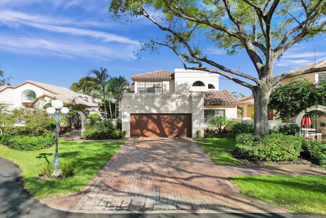 mediterranean / spanish-style house with a front yard and a garage