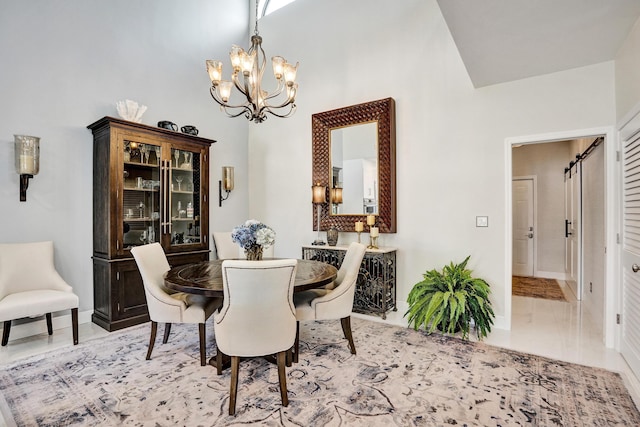 dining room featuring a chandelier and a high ceiling