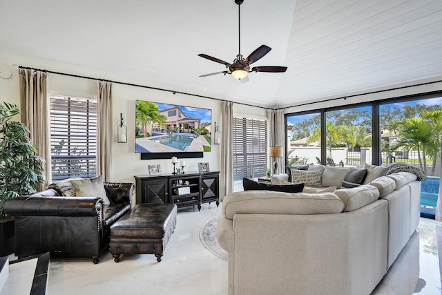 living room featuring a towering ceiling and ceiling fan