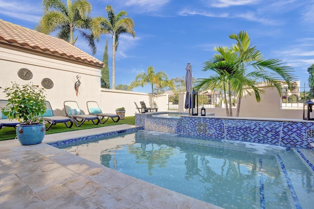 view of pool with an in ground hot tub