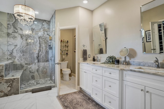 bathroom featuring vanity, toilet, tiled shower, and an inviting chandelier