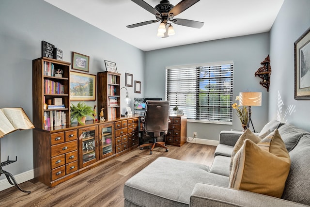 office area with light wood-type flooring and ceiling fan