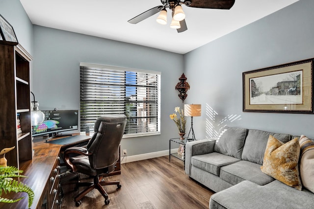 office with ceiling fan and dark wood-type flooring