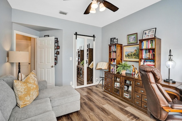 home office with ceiling fan and hardwood / wood-style floors