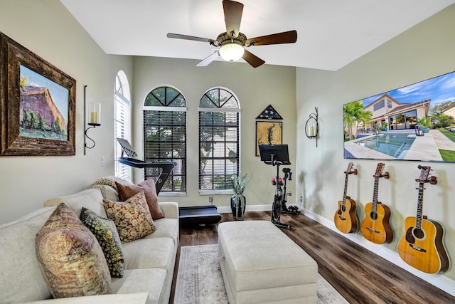 living room featuring ceiling fan and dark wood-type flooring