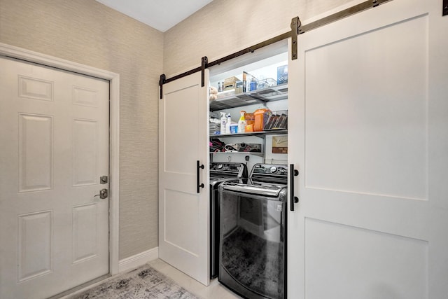 laundry area featuring separate washer and dryer and a barn door