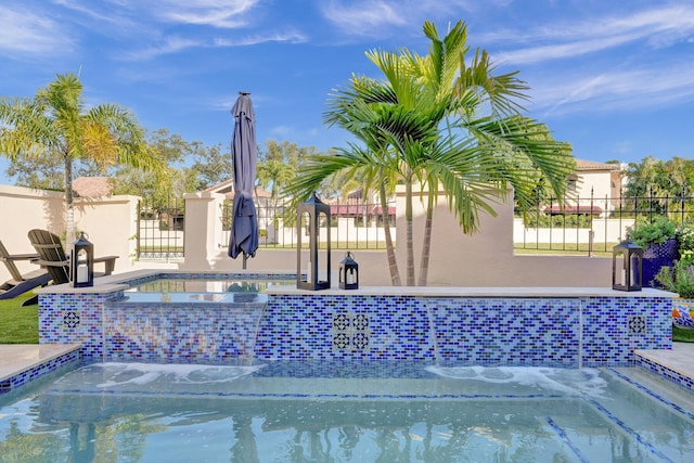 view of swimming pool with a hot tub