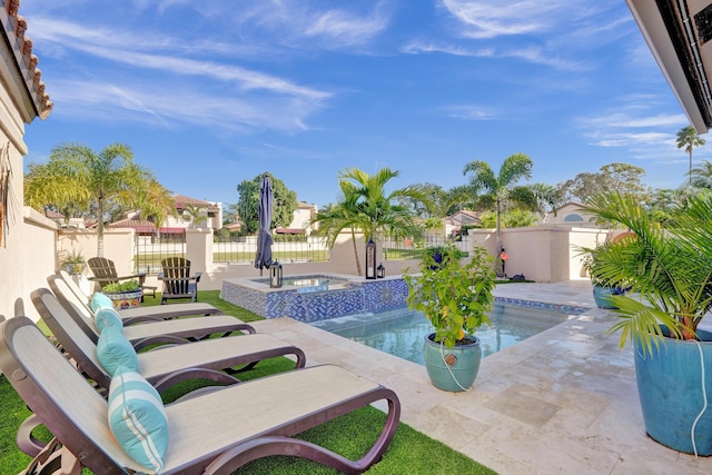 view of swimming pool featuring an in ground hot tub and a patio